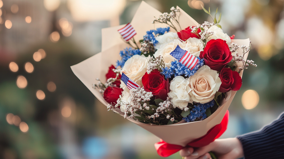 Wrapped 4th of July bouquet in red, white, and blue with small flags and sparkler decorations.