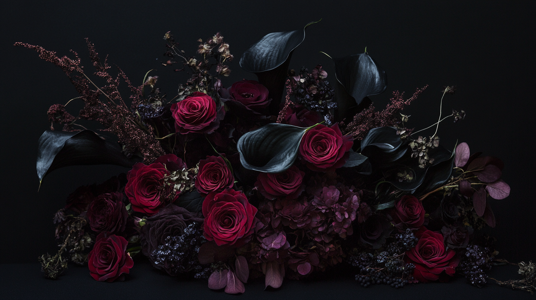 Elegant Halloween flower arrangement with dark roses and black calla lilies styled in soft light against a neutral background.