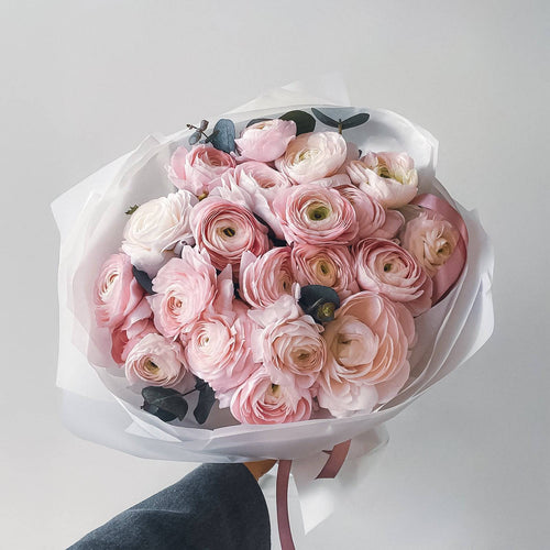 Blush Whispers bouquet with 24 pink ranunculus in white wrap
