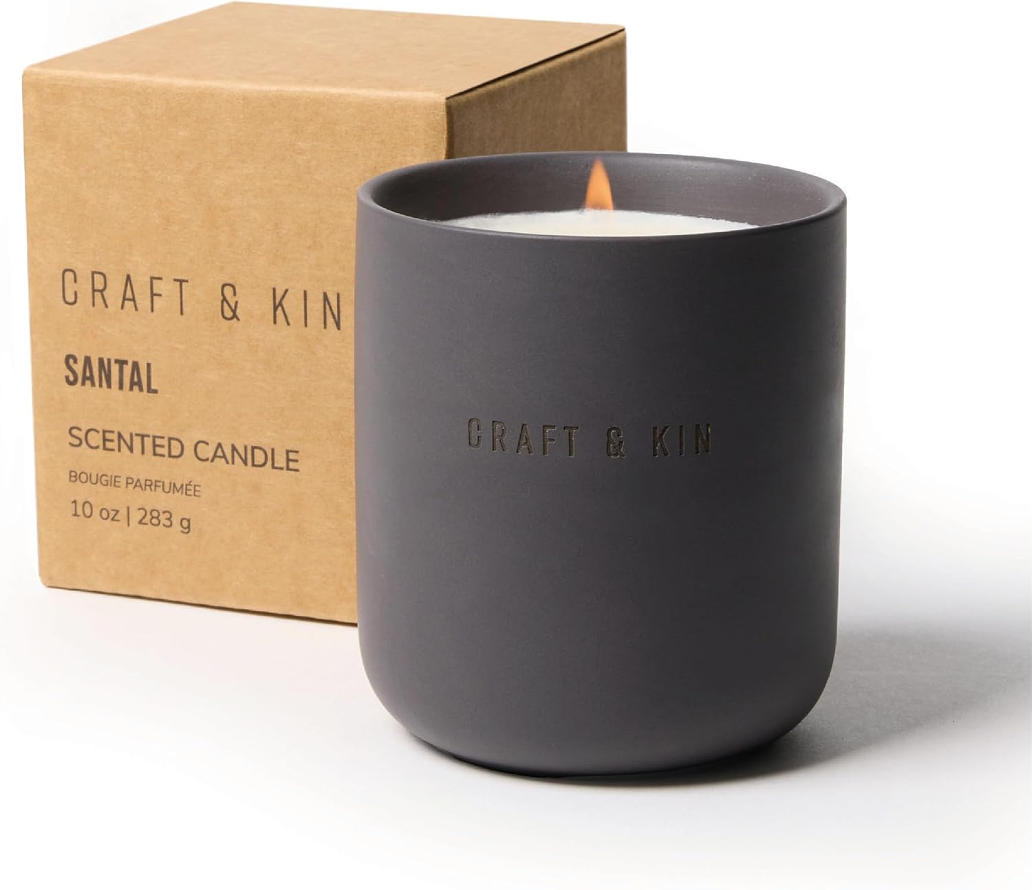 Dark gray candle with 'Craft & Kin' branding next to a brown box packaging - Santal scent