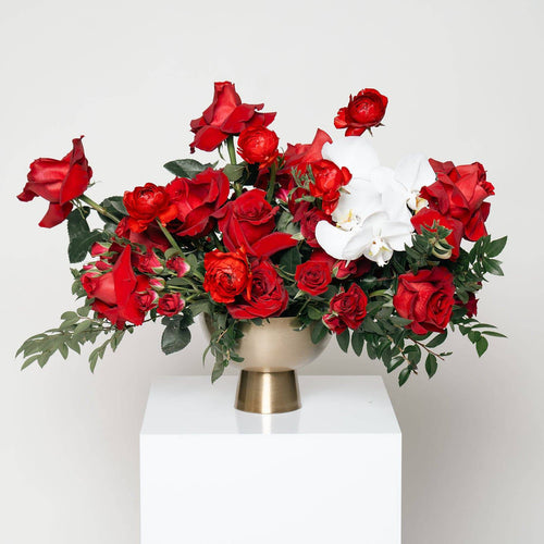 Blush of Love bouquet with red roses and white orchids in gold vase