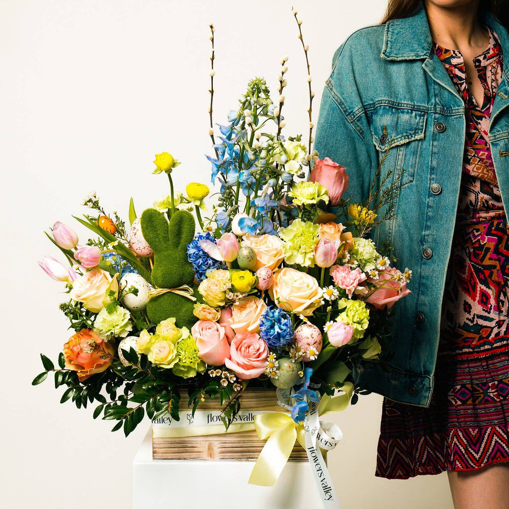 Model holding Easter Meadow bouquet with pastel spring flowers