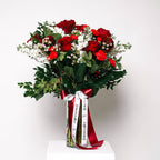 Timeless Red bouquet with red roses and white blooms in clear vase