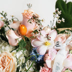 Close-up of Easter flower basket with blush roses and seasonal accents