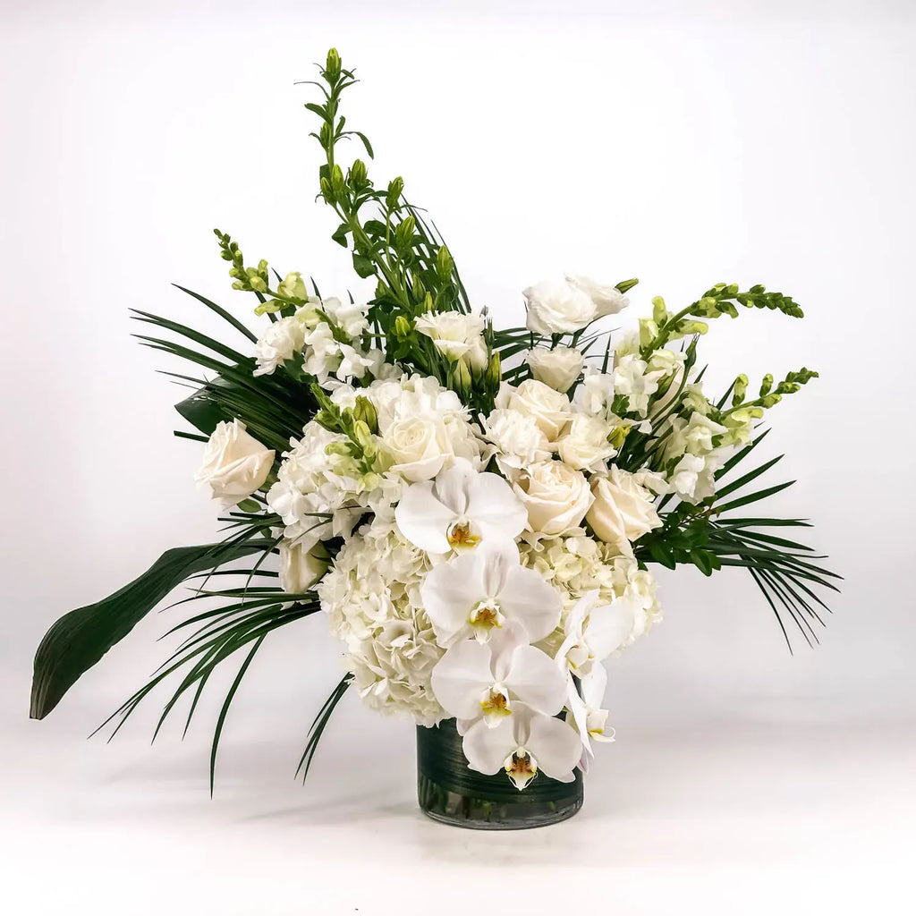 Another view of Graceful Eternity white sympathy flower arrangement showing the volume of the orchids, hydrangea and roses