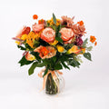 Bouquet of flowers in a clear vase on a white background - Premium Flower Subscription