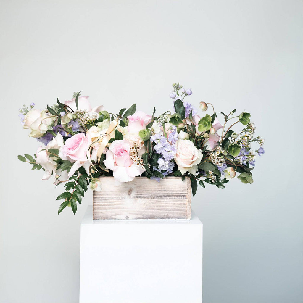 Lavender Bliss bouquet with blush roses and lavender stock in a white wooden box