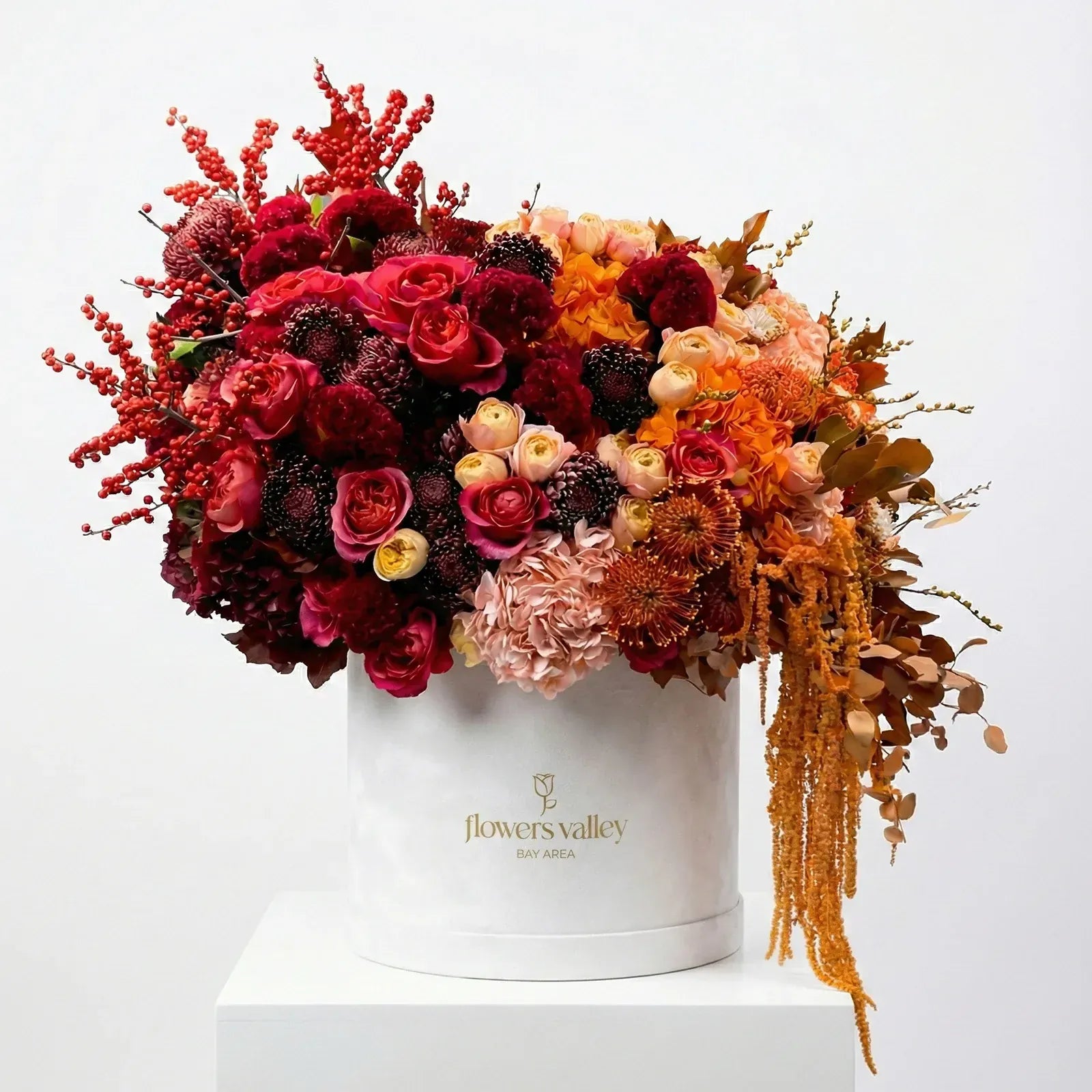 Luxury autumn flower box with claret red and amber blooms in a signature Flowers Valley box