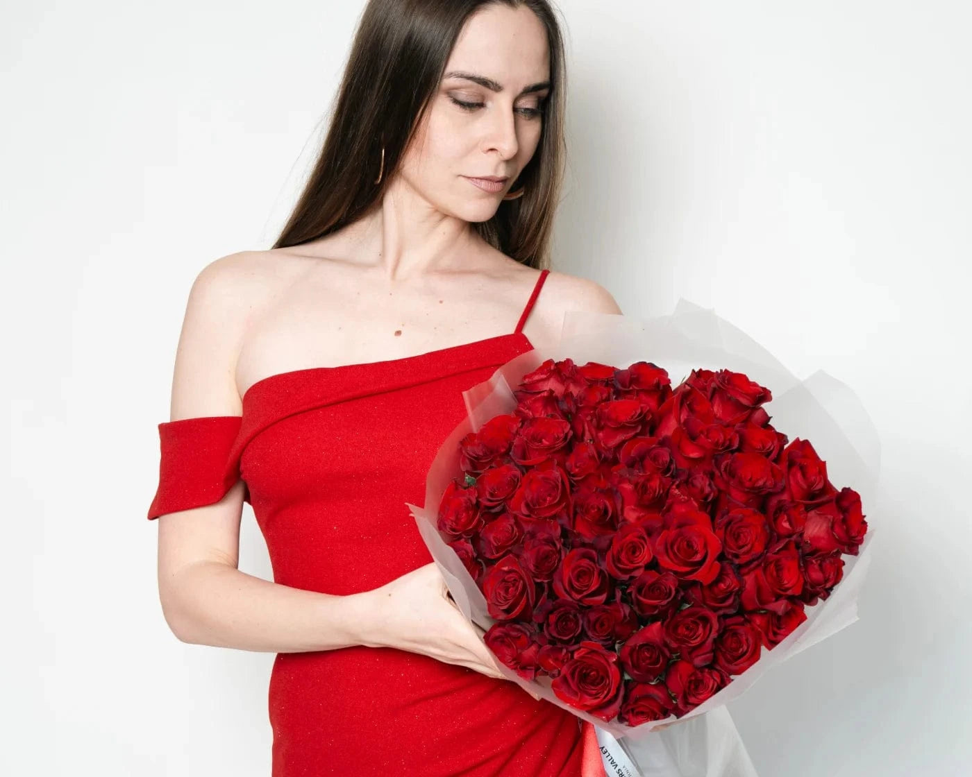 Woman in red dress holding a romantic bouquet of red roses in American Canyon – Flowers Valley delivery