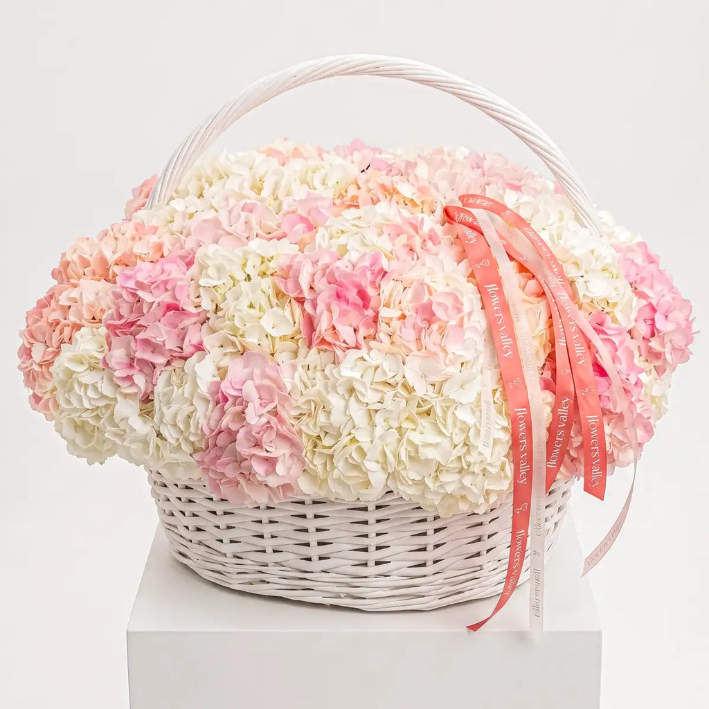 Blush and ivory hydrangea flower basket in a white wicker basket with Flowers Valley ribbon, luxury arrangement by Bay Area florist