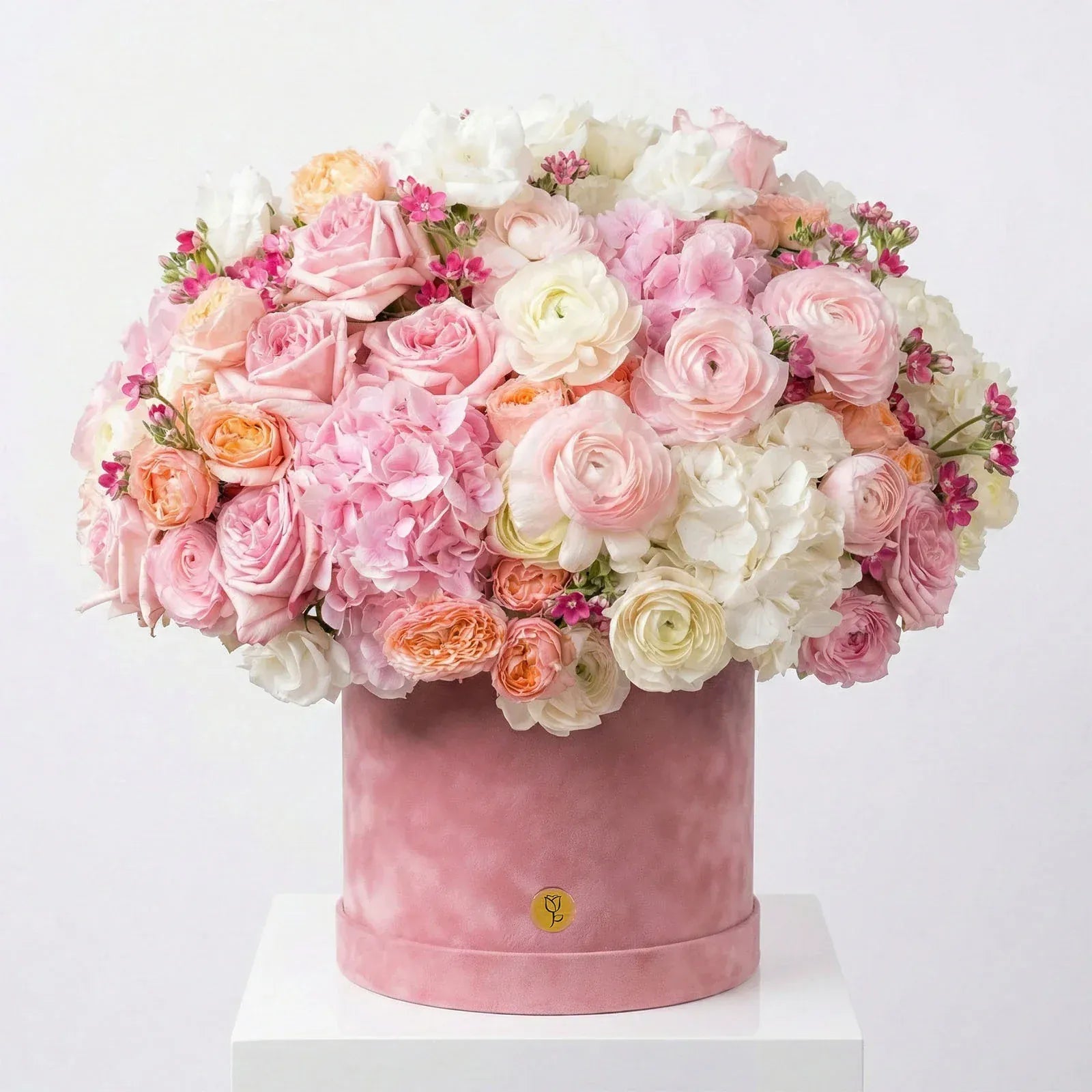 Luxury pink hatbox flower arrangement with roses, ranunculus, and hydrangea by Flowers Valley