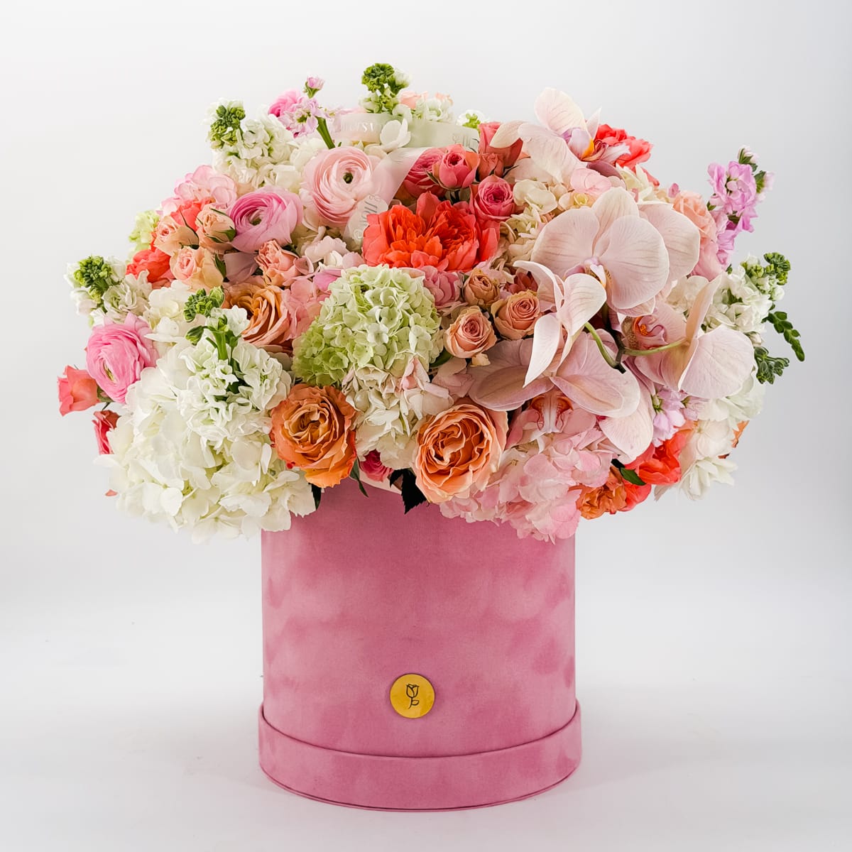 Luxury pink hatbox flower arrangement with roses, ranunculus, and hydrangea by Flowers Valley