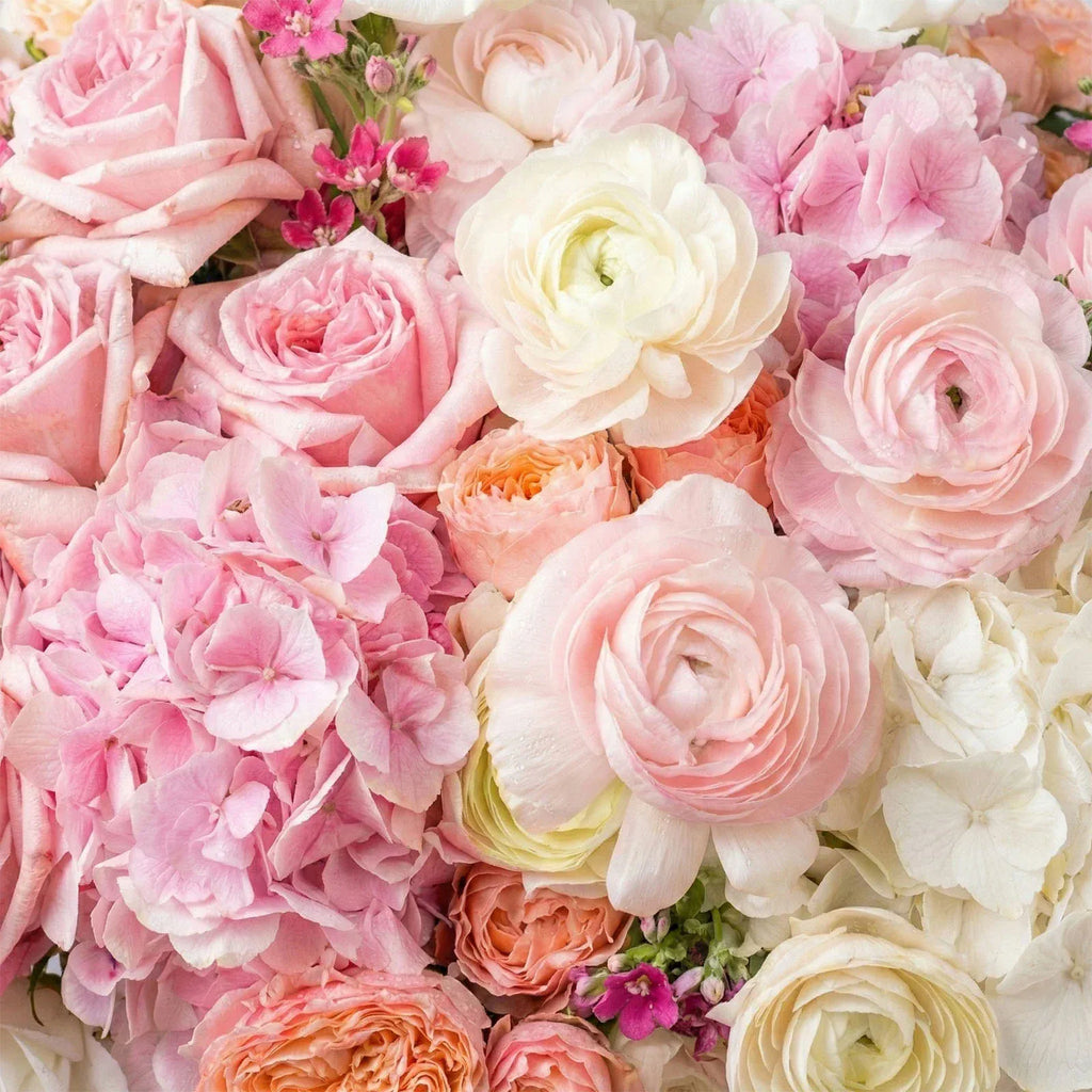 Close-up of blush roses, ranunculus, and soft pink hydrangea in a luxury floral design