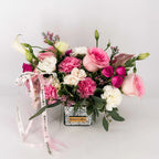 Close-up of Blushing Grace arrangement with blush roses, pink carnations, and spray roses in soft seasonal tones.