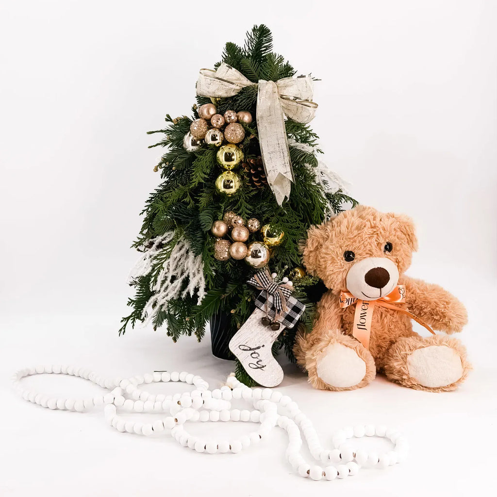 Champagne Glow Tree displayed with teddy bear, elegant gold holiday mini tree arrangement perfect for gifting by Flowers Valley.