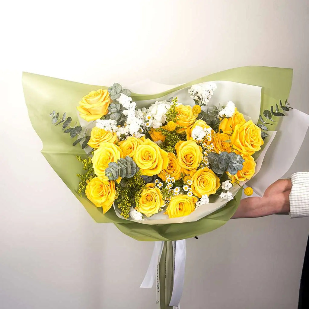 Citrine bouquet of yellow roses, white statice, chamomile and eucalyptus in a sage green wrap by Flowers Valley, Bay Area flower delivery