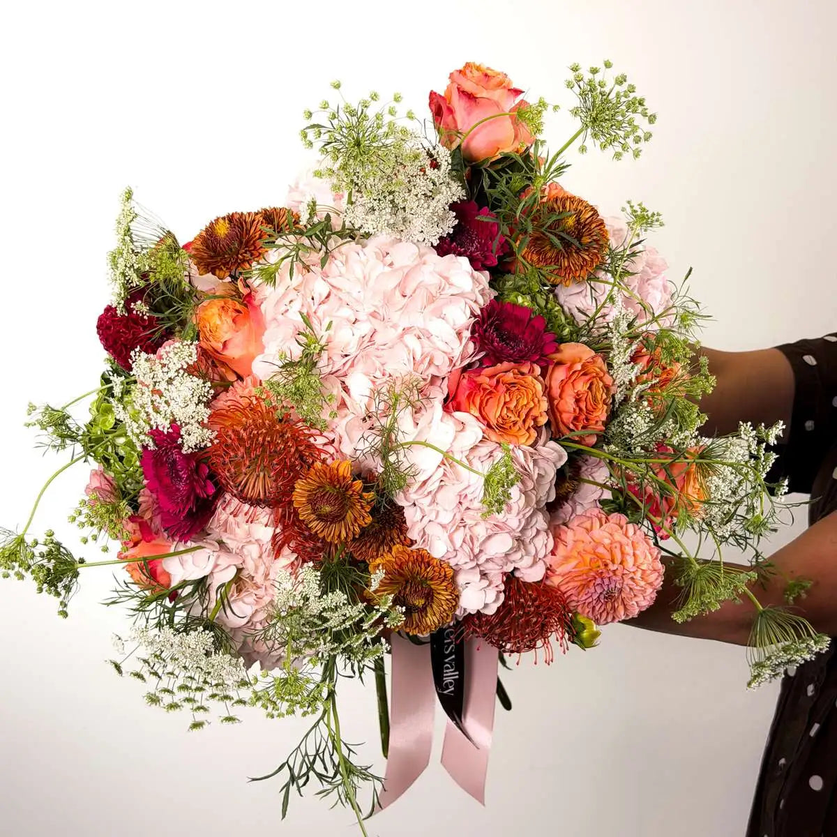 Copper Rosé fall bouquet with pink hydrangea, peach garden roses, pincushion protea and bronze chrysanthemums tied with a blush ribbon — Flowers Valley Bay Area delivery