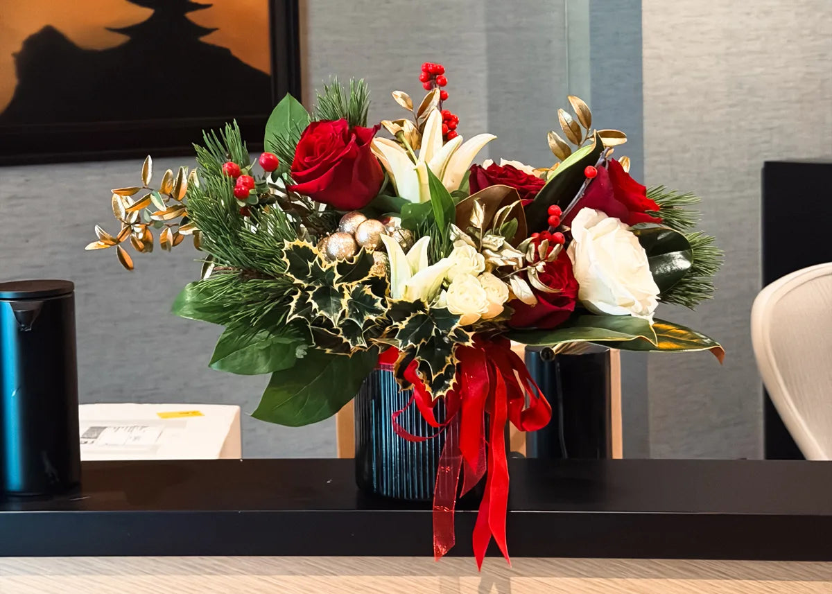 Decorative flower arrangement on a desk in an office setting delivered as a flower subscription 
