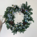Modern Christmas wreath with iridescent glass ornaments and fresh evergreens by Flowers Valley