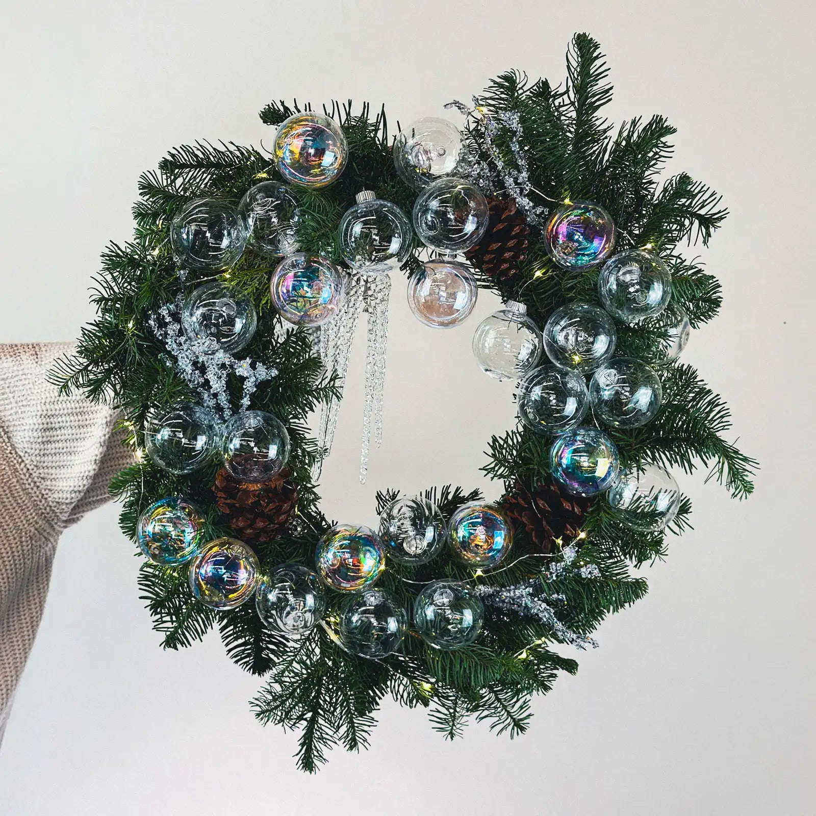 Modern Christmas wreath with iridescent glass ornaments and fresh evergreens by Flowers Valley