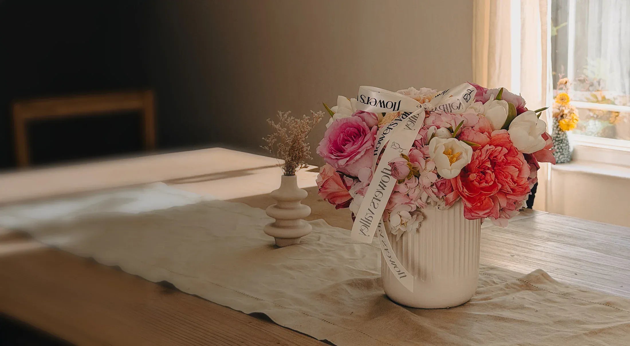 Floral arrangement in a vase on a table with a soft focus background