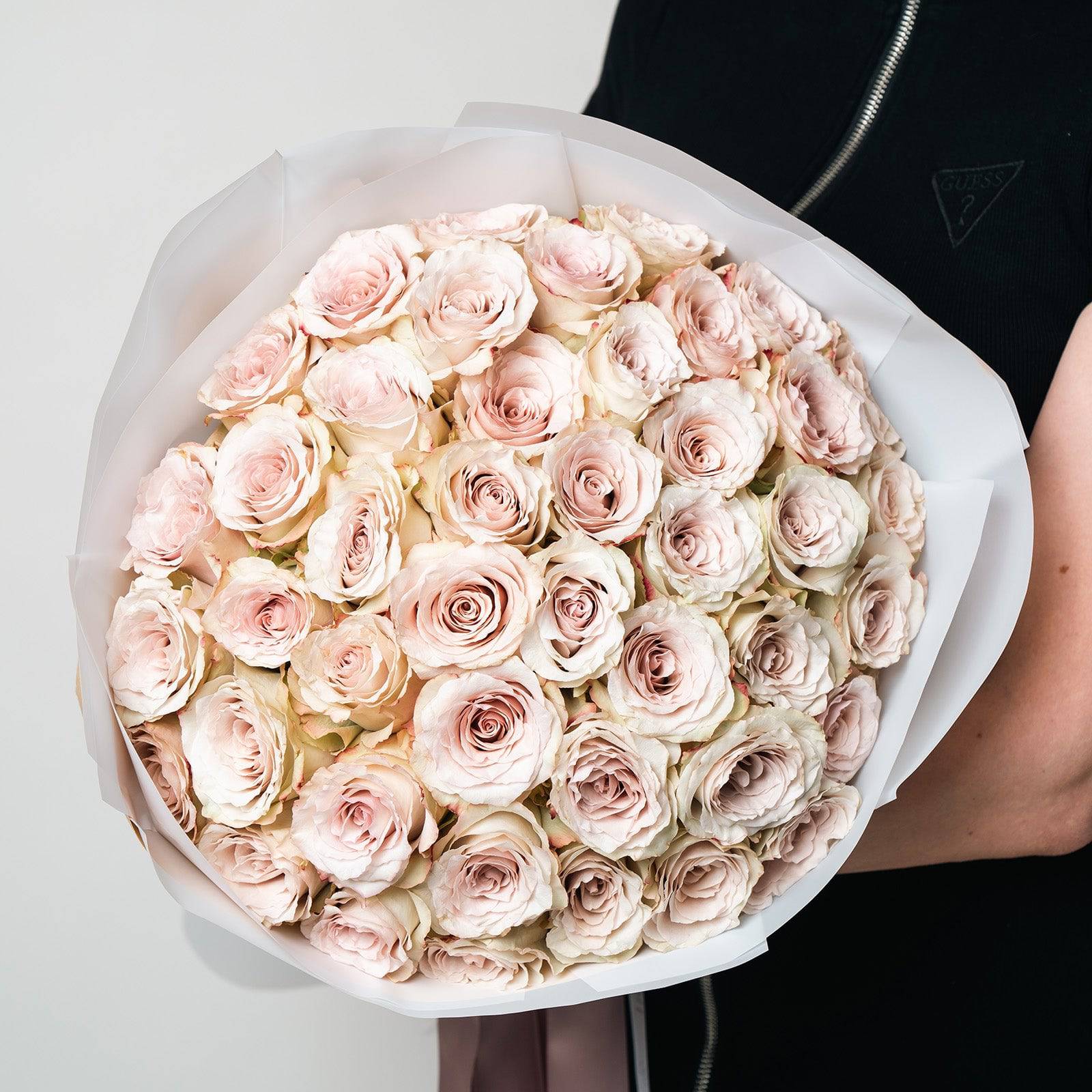Luxury Quicksand Roses bouquet featuring 50 blush-beige roses with velvety petals, elegantly wrapped in white paper.