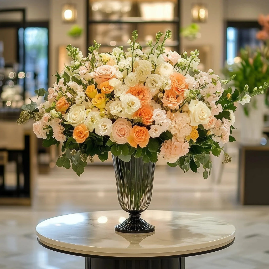 Luxury grand lobby flower display with white roses, lilies, and lush greenery in a tall glass vase – Flowers Valley