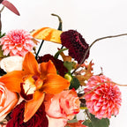 Close-up of Harvest Majesty Pumpkin Arrangement with orange orchid, rose, and pink dahlia