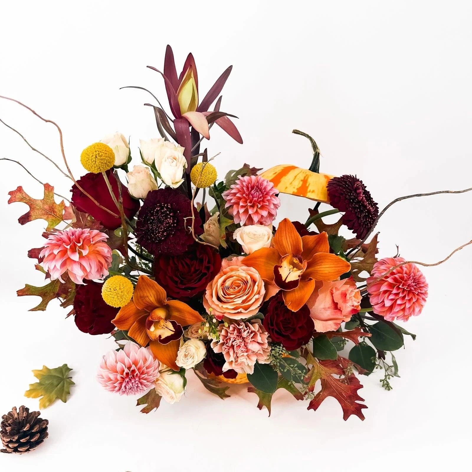 Top angle of Harvest Majesty Pumpkin Arrangement showcasing vibrant autumn blooms and pumpkin vessel