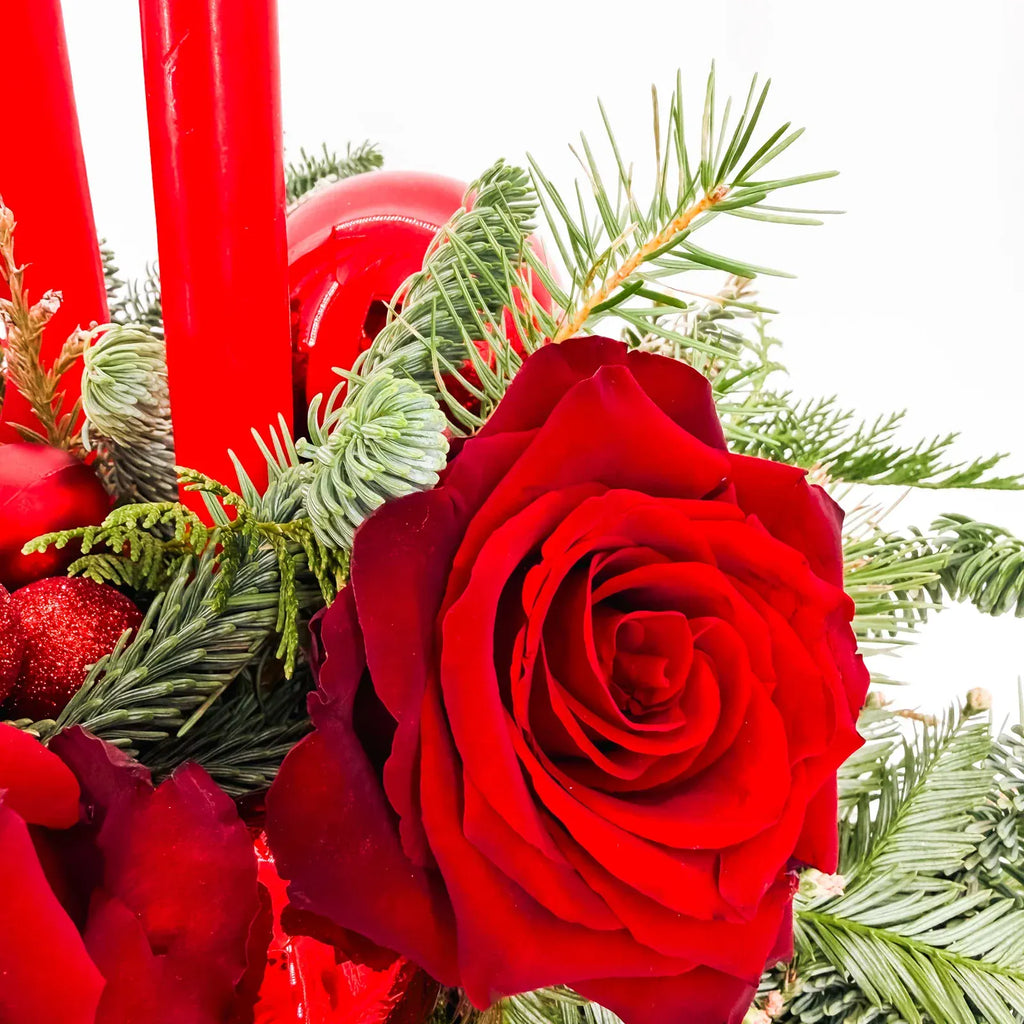 Close-up of red rose and evergreen accents in Holiday Glow Centerpiece