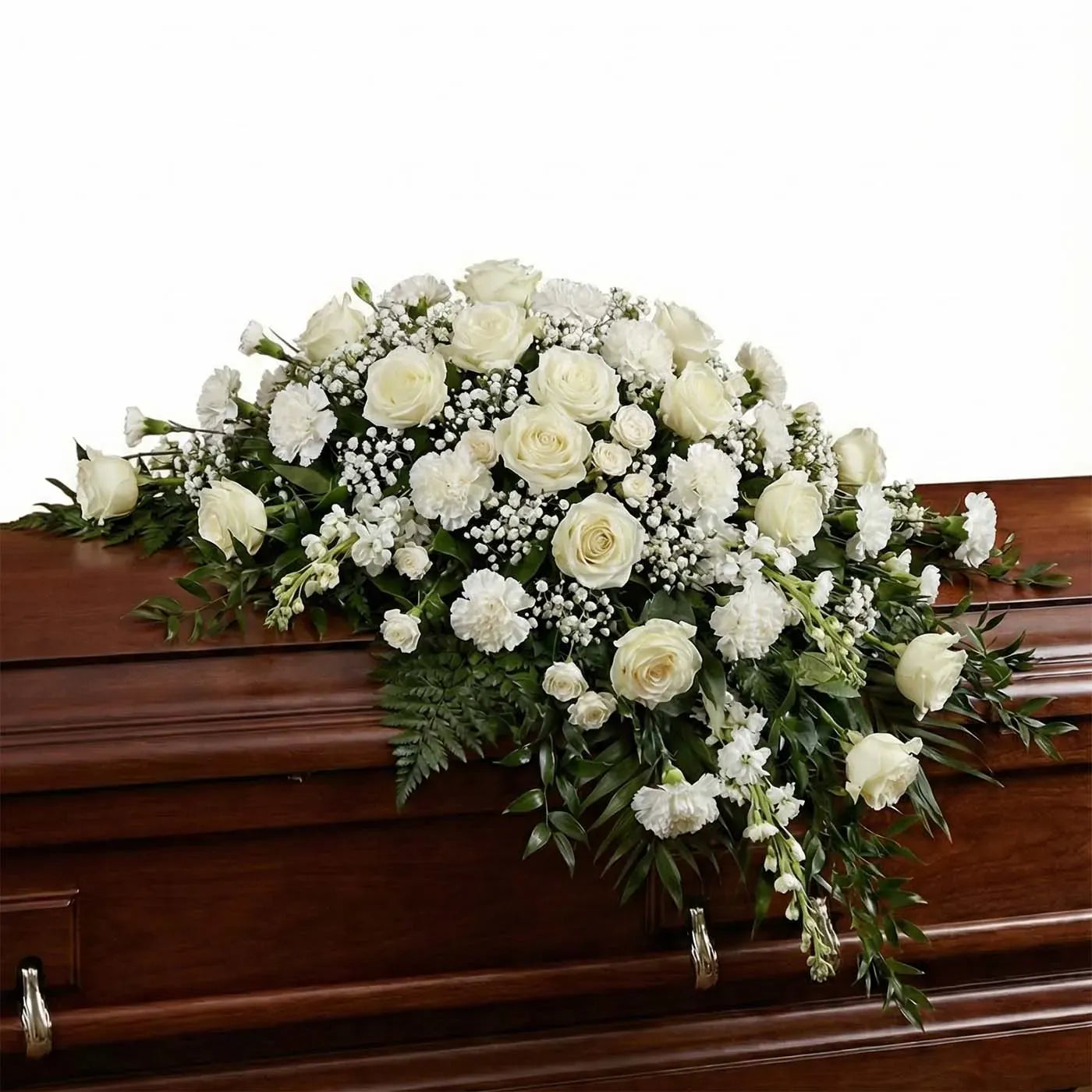 Standard white casket arrangement with ivory roses and fern greenery