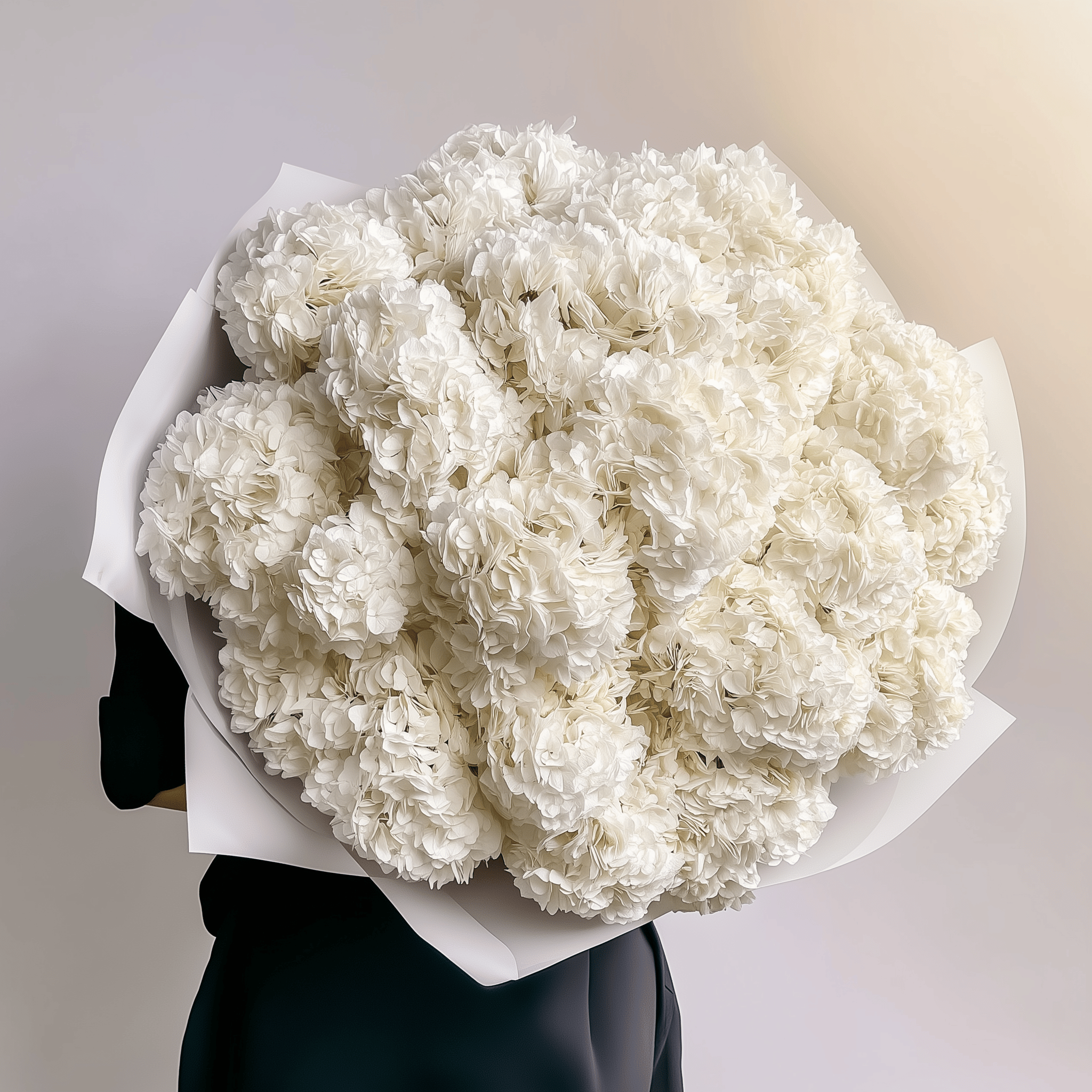 Creamy white hydrangeas with soft texture, wrapped in white—timeless and elegant.
