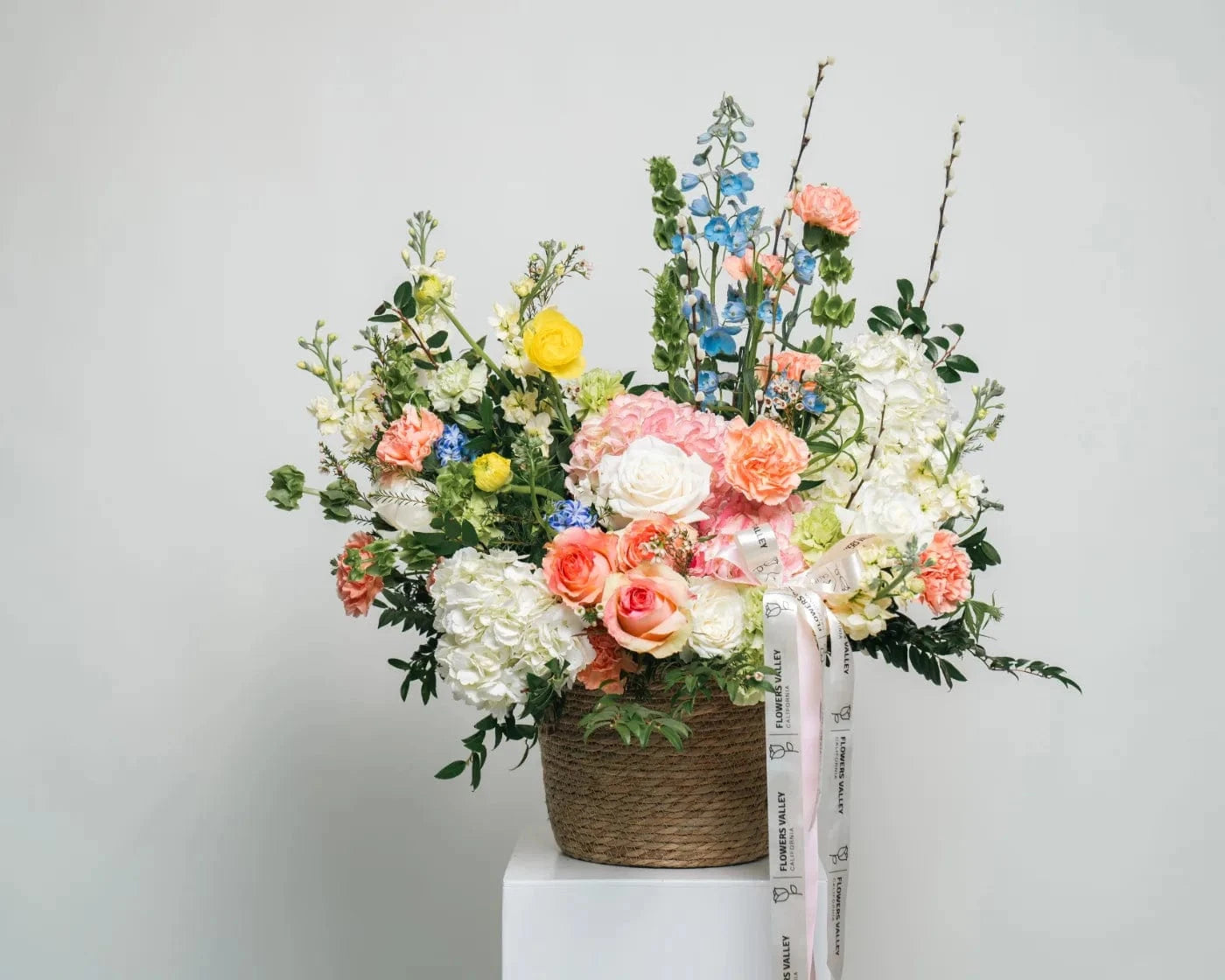 Elegant floral arrangement with roses, hydrangeas, and mixed seasonal blooms in a basket – Flowers Valley Mountain View flower delivery