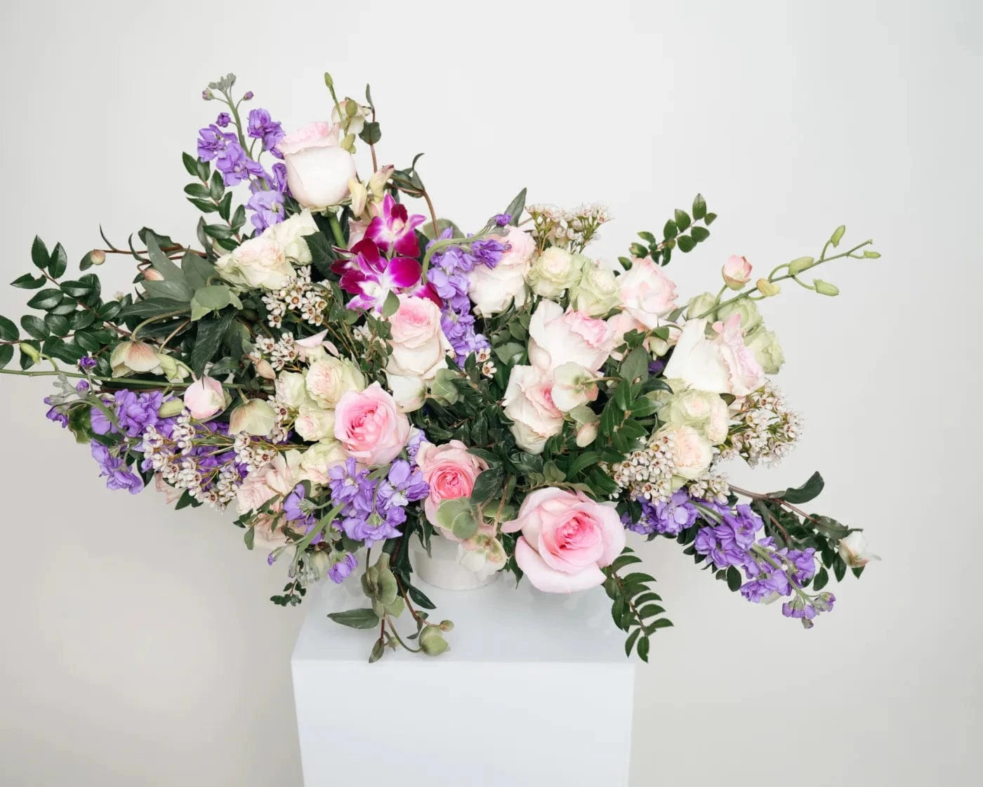 Luxury mixed floral arrangement with pastel roses, orchids, and purple seasonal flowers – Flowers Valley Antioch flower delivery