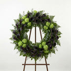 Modern funeral wreath with dark purple calla lilies and green hydrangea