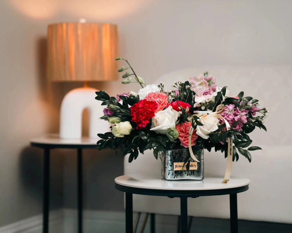 Elegant mixed flower arrangement with roses, carnations, and seasonal blooms in a glass vase – Flowers Valley Larkspur flower delivery