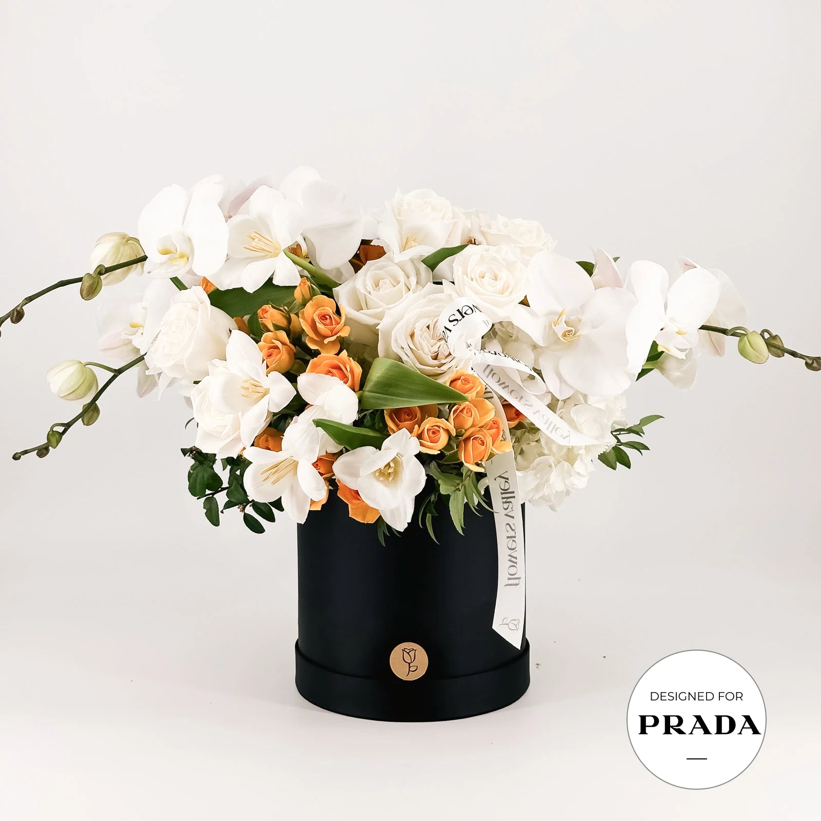 Premium floral arrangement  in a black box with 'Designed for Prada' label on a white background made by Flowers Valley