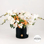 Premium floral arrangement  in a black box with 'Designer for Prada' label on a white background made by Flowers Valley