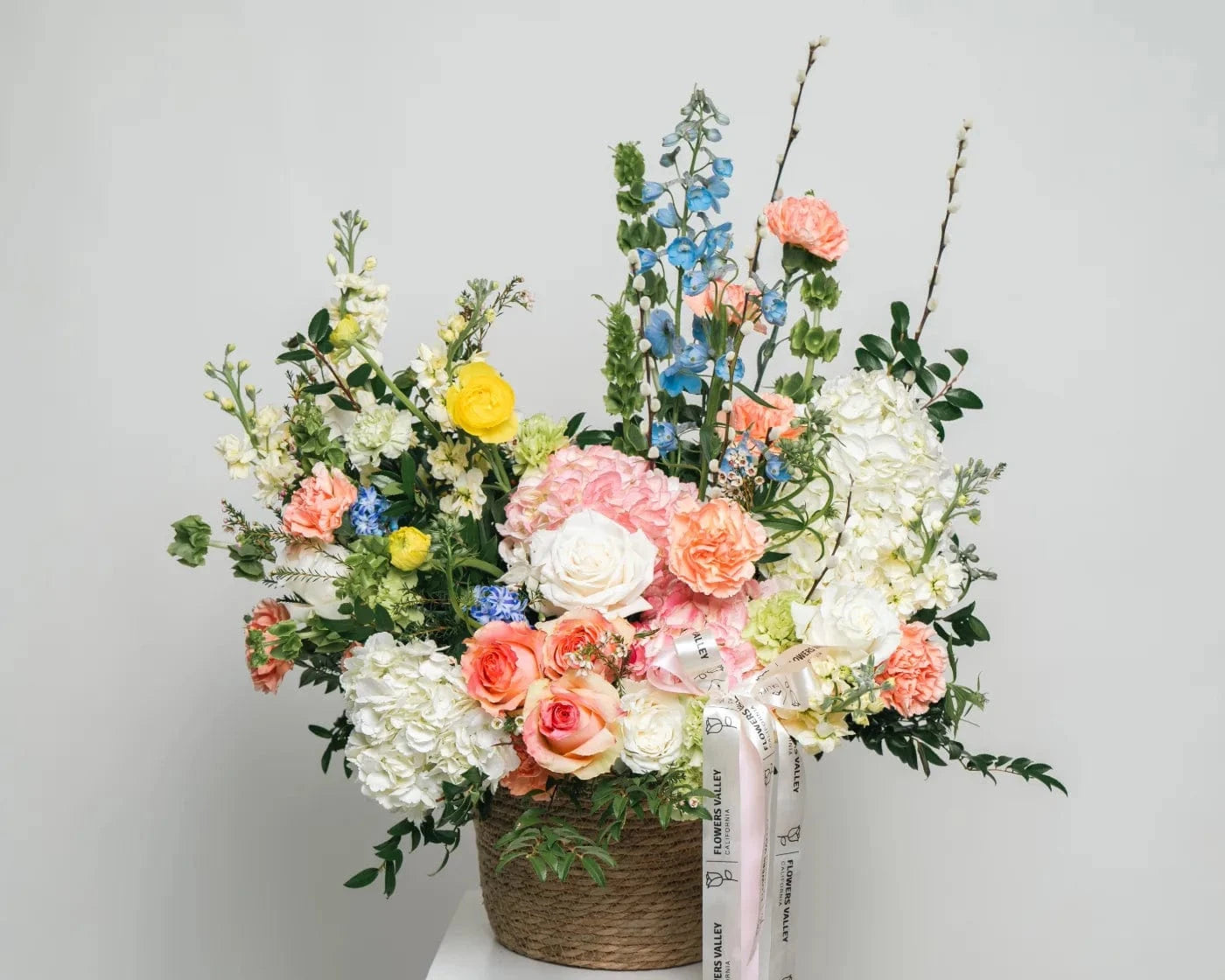 Elegant pastel flower arrangement with roses, hydrangeas, and seasonal blooms in a basket – Flowers Valley Dixon CA flower delivery