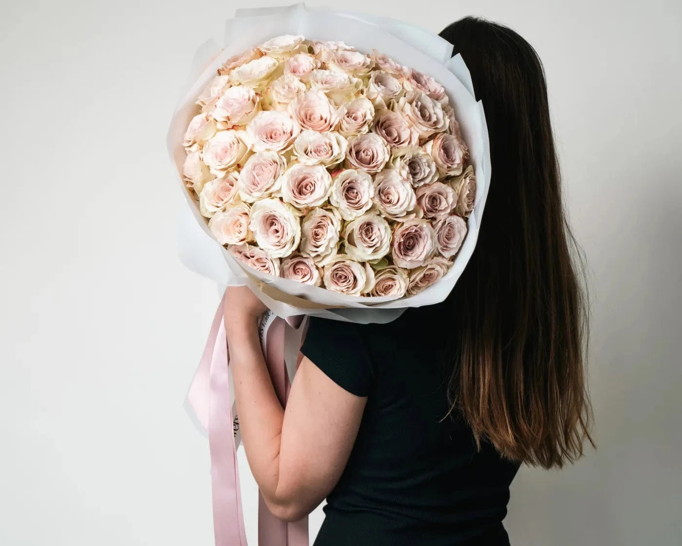 Woman holding a large bouquet of soft pink roses – Flowers Valley flower delivery in South San Francisco, CA
