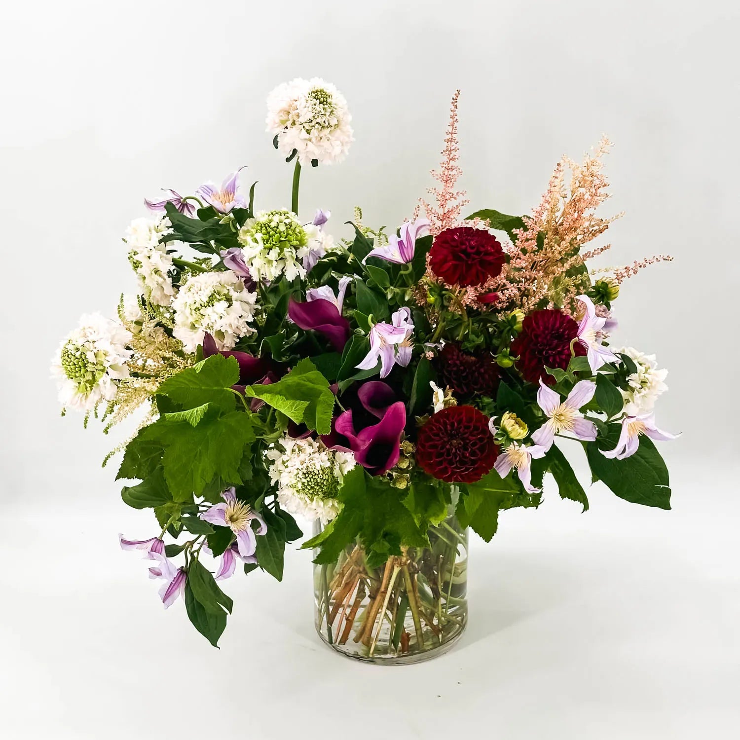 Organic sympathy flowers with dahlias, clematis, and soft seasonal accents