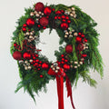 Red Velvet Holiday Wreath with red ornaments and evergreens by Flowers Valley