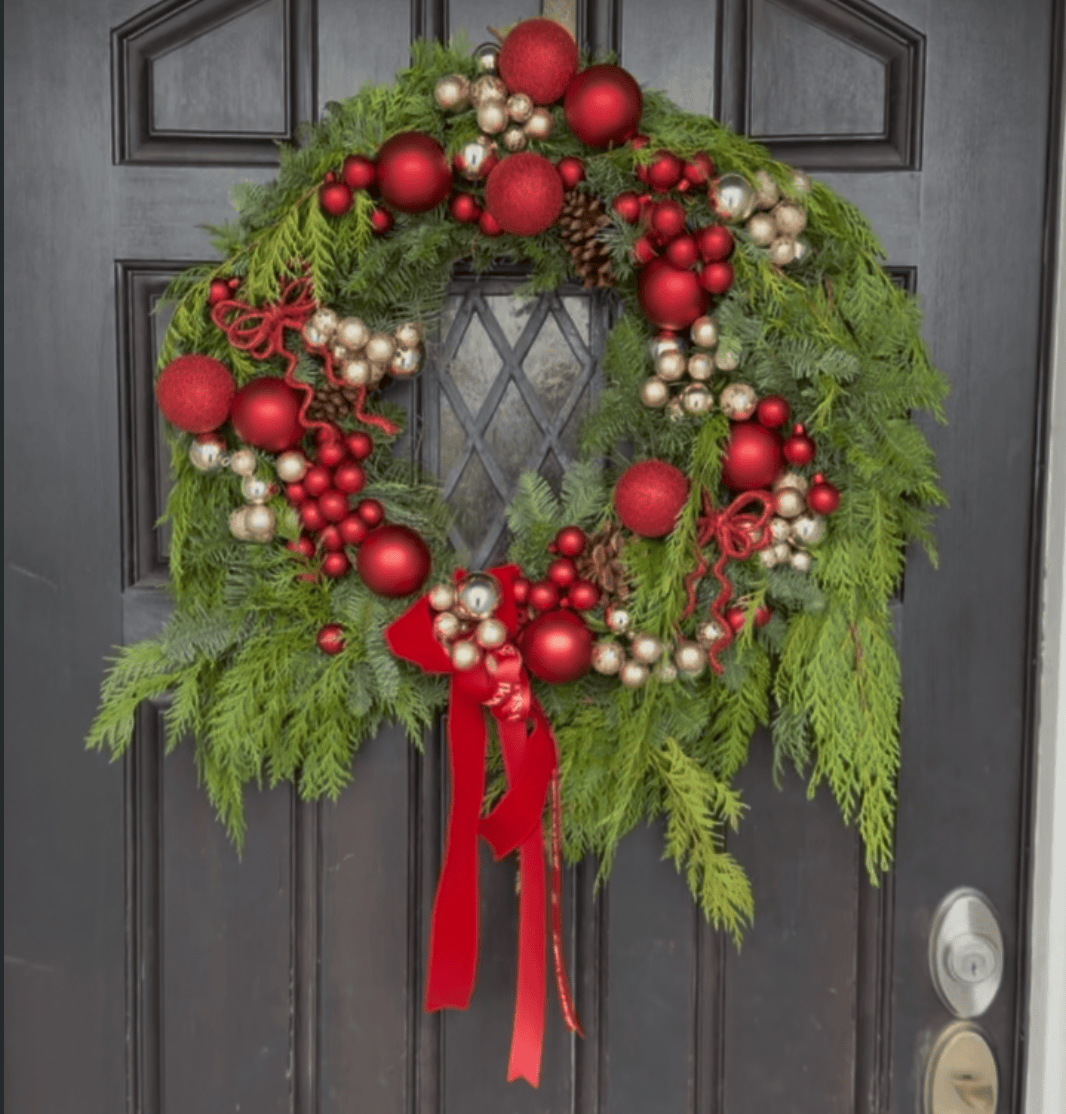 Red Velvet Holiday Wreath hanging on front door with red ornaments