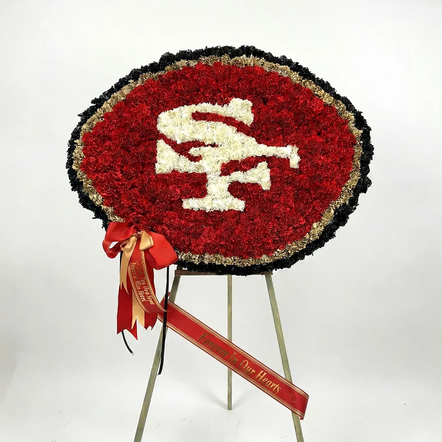 San Francisco 49ers floral memorial wreath on easel with red ribbon