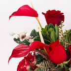 Close-up of Scarlet Lights Arrangement with red anthuriums, roses, and golden accents