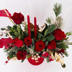 Top view of Scarlet Lights Arrangement with candles, festive roses, and holiday foliage