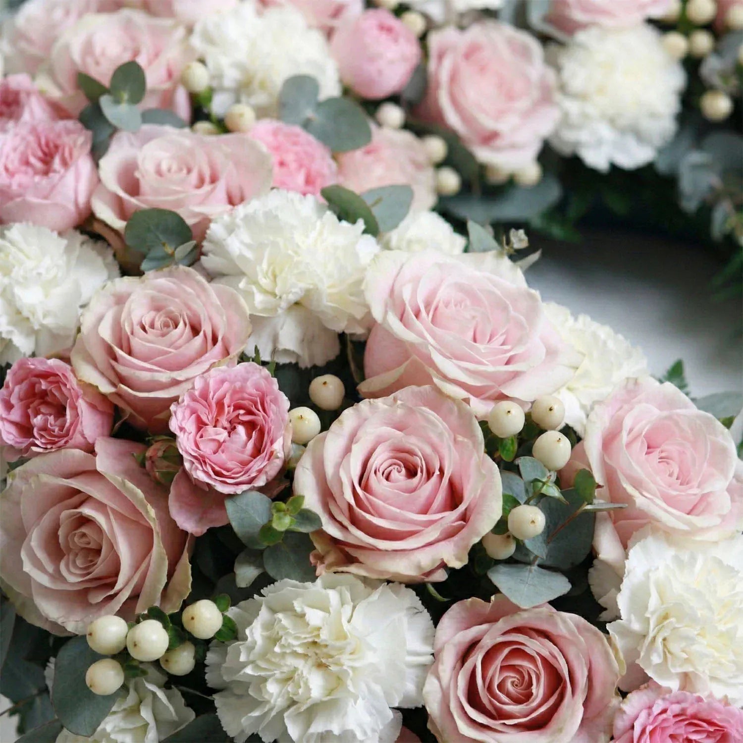 Serene Farewell Wreath close-up view featuring roses and carnations