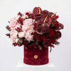 Velvet Garnet luxury flower box featuring burgundy, blush, and crimson blooms in a velvet hat box