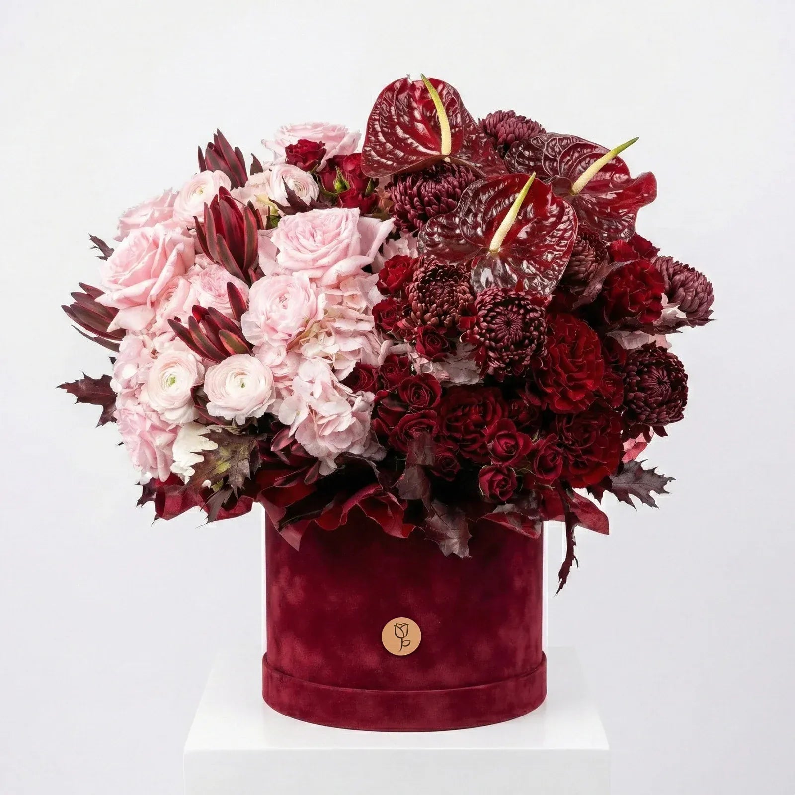 Velvet Garnet luxury flower box featuring burgundy, blush, and crimson blooms in a velvet hat box
