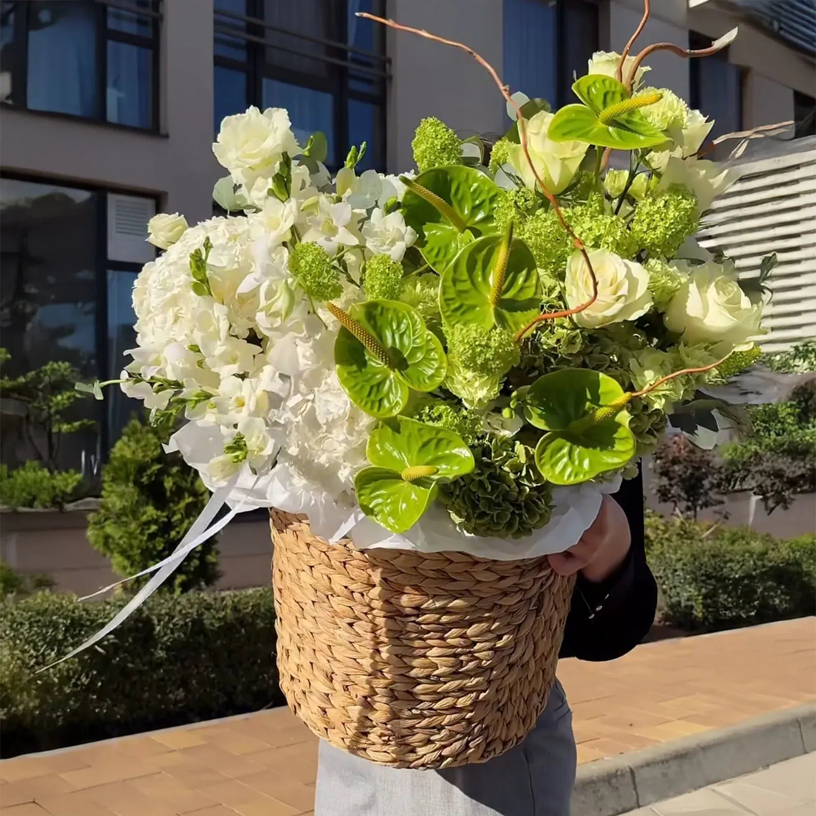 Modern white and green floral centerpiece in natural basket, Bay Area florist
